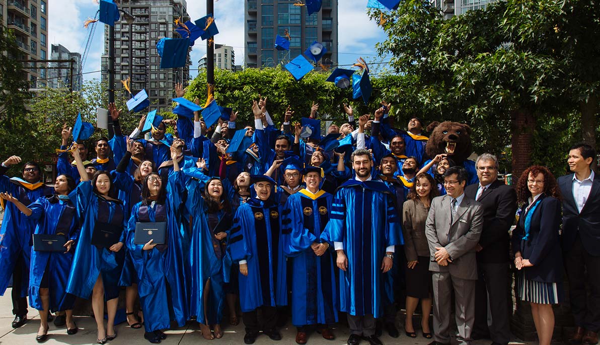 Vancouver graduates throwing commencement caps in the air