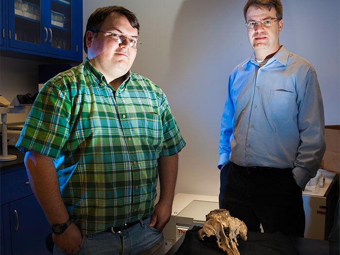 Morgan Churchill, Ph.D. and Jonathan Geisler, Ph.D. with 27-million-year-old fossil skull of Echovenator