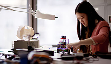 NYIT student working on a robot