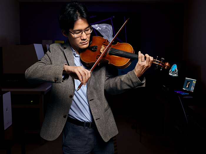 Akinobu “Aki” Watanabe, Ph.D., assistant professor of anatomy in the College of Osteopathic Medicine, playing violin