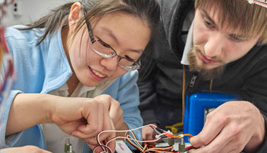 NYIT students with electronics