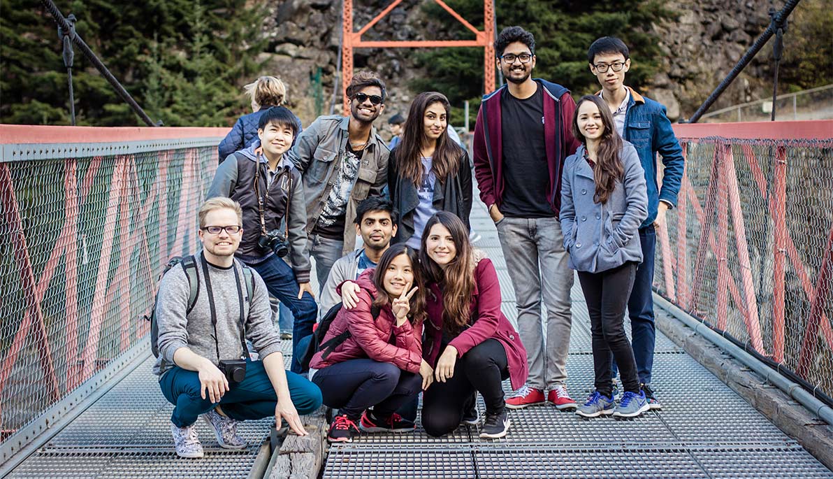NYIT students pose on a bridge over the Fraser River.