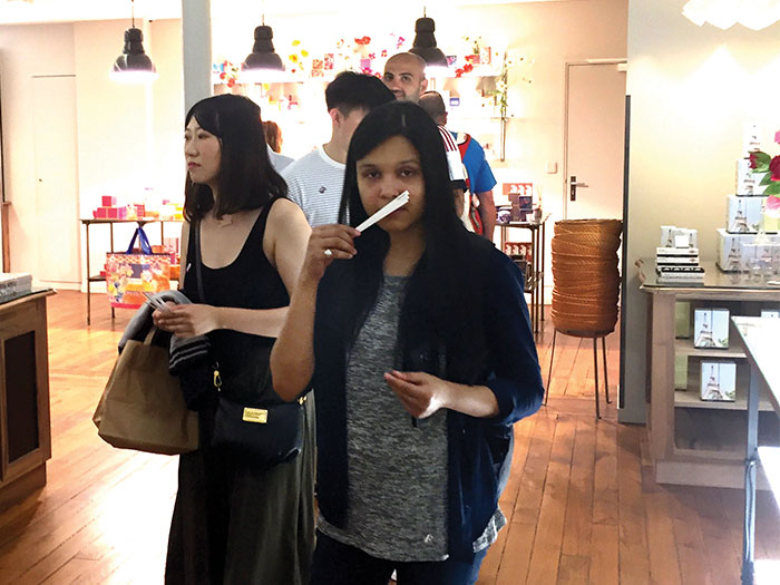 NYIT students walking in a Parisian shop.