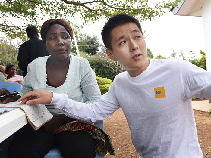 Panfeng Liu helps Renalda Materu learn about conducting business in English at the Excel Education Foundation in Moshi, Tanzania.