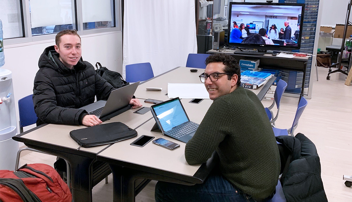 Photo of two students, Robert Doxey (right) and Alex Atrachji (left) working  at the New York Tech ETIC 