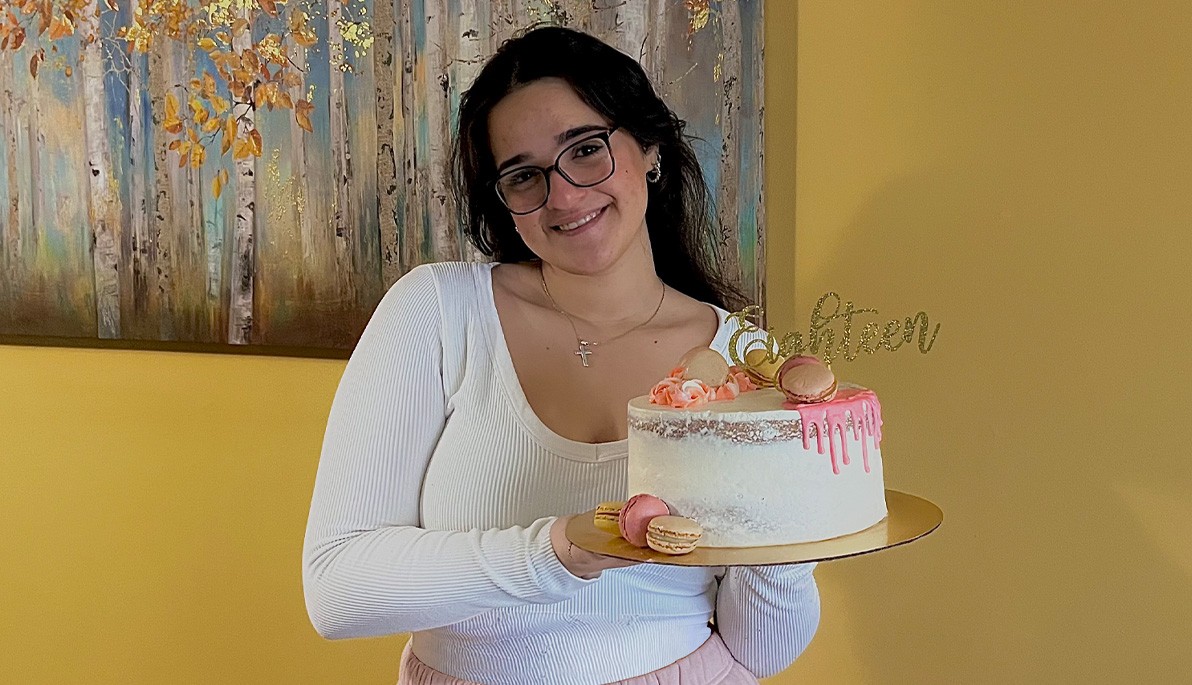 New York Tech student Michelle Charidemou holding a cake
