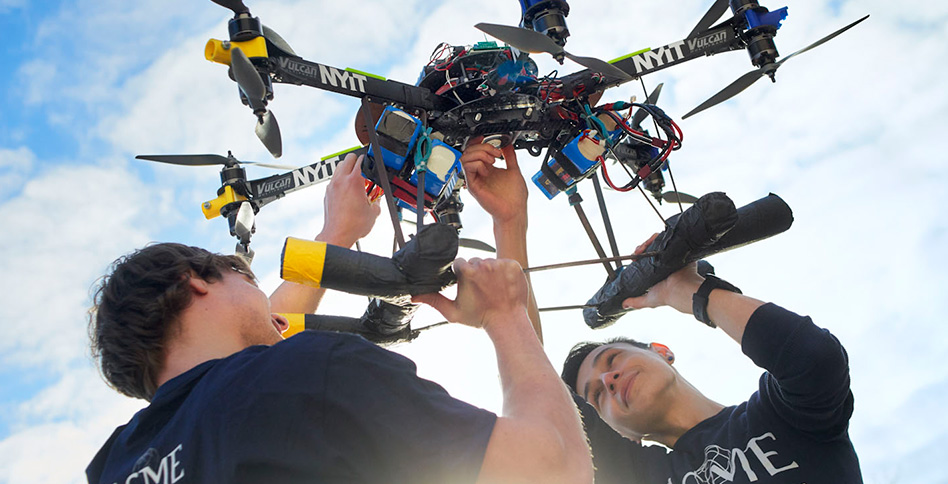 Students with drones above their heads