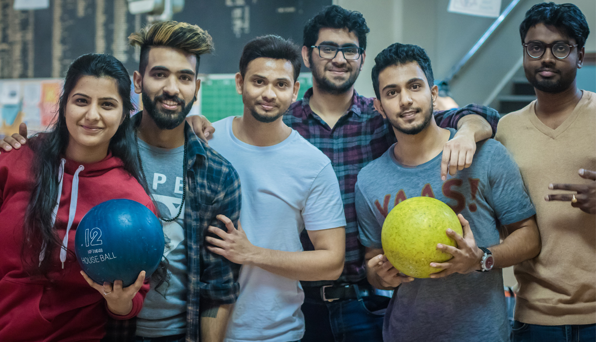 Students holding bowling balls