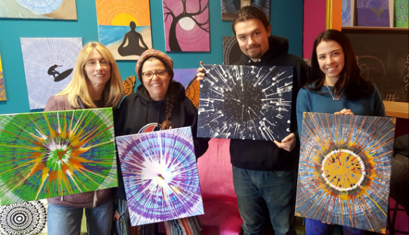 Attendees showcasing artwork created at Casa de Spin