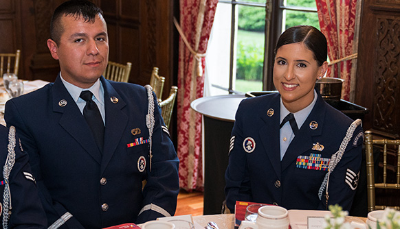Two student veterans in uniform at a luncheon table