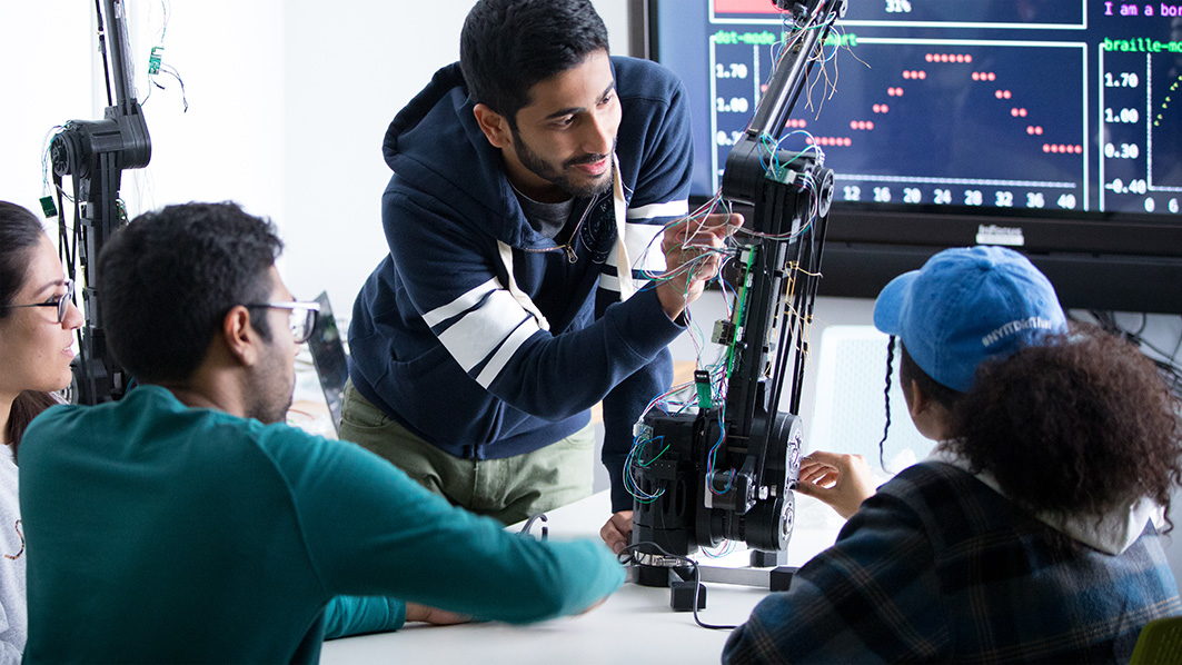 NYIT students working on robotic arm