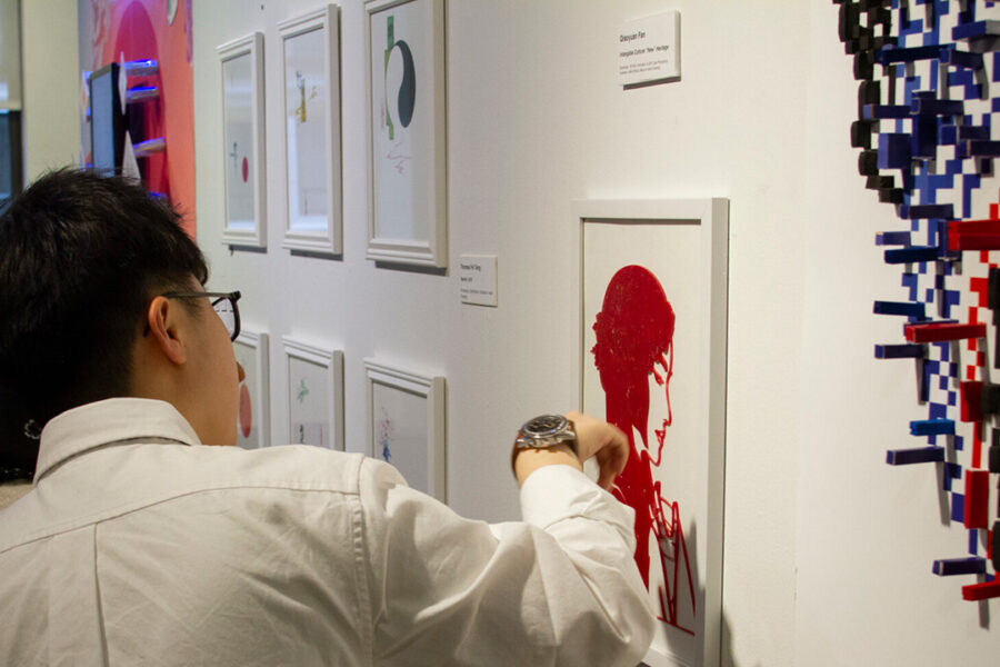 A person looks at art displayed at New York Tech's Gallery 61.