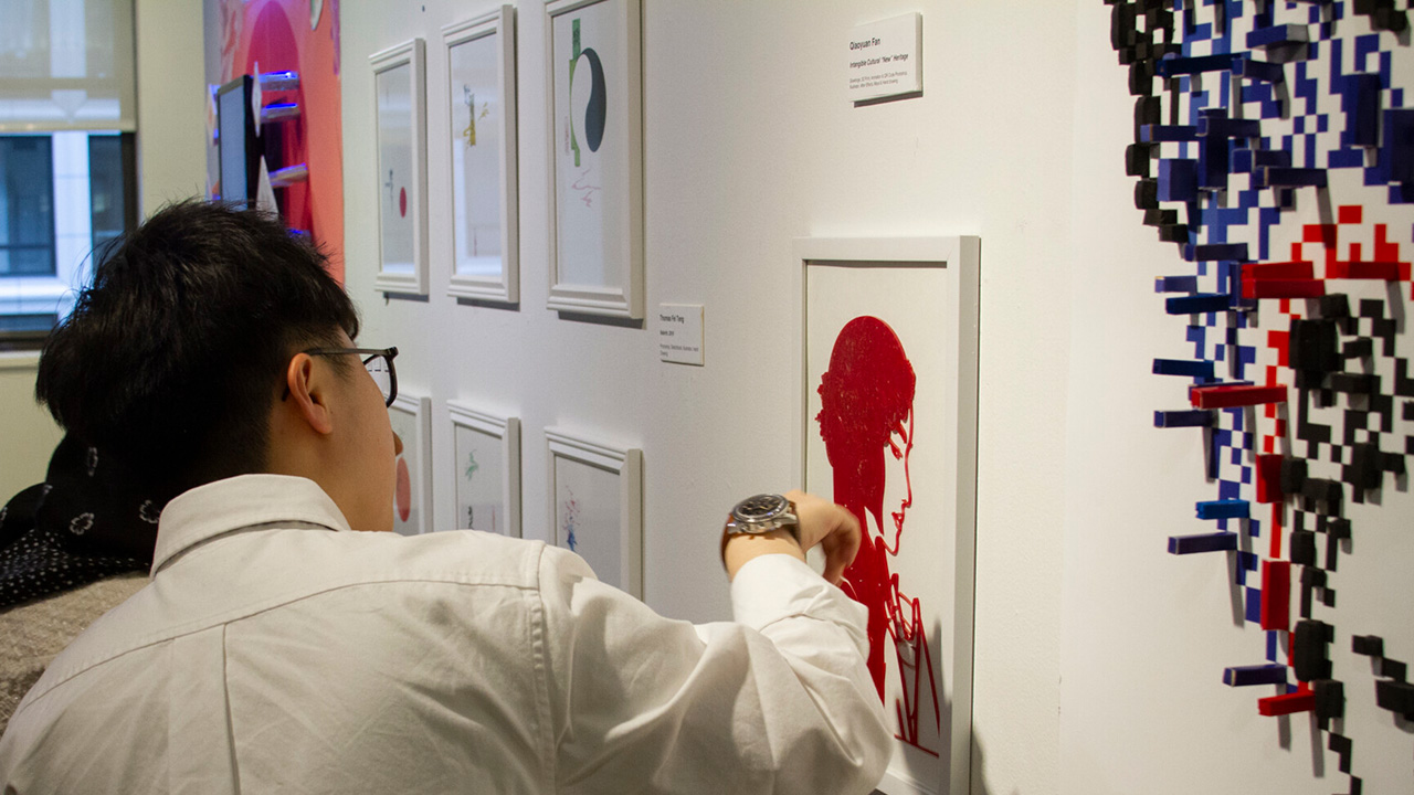 A person looks at art displayed at New York Tech's Gallery 61.