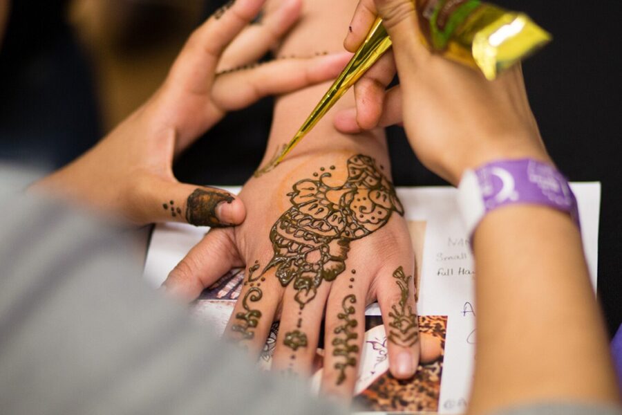 Henna being applied to a hand.