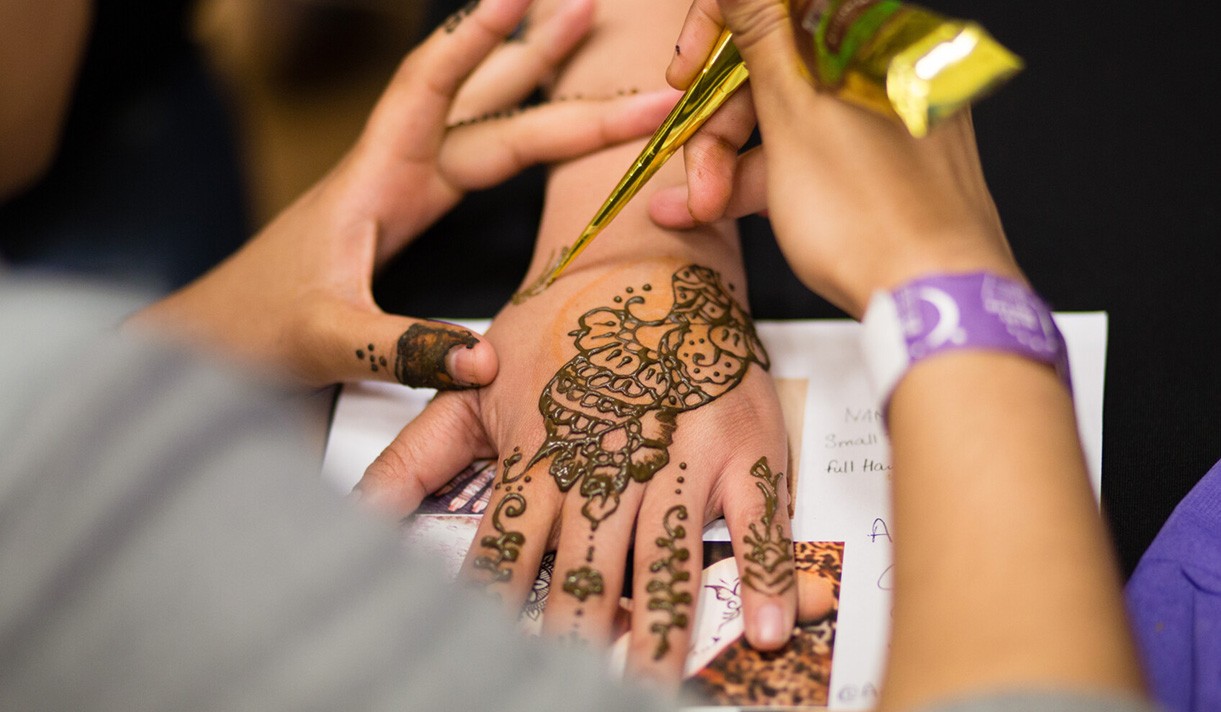 Henna being applied to a hand.