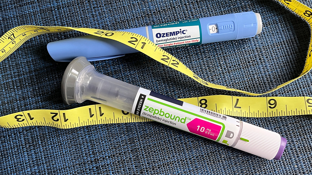 Medication and a tape measure representing an obesity and health conference.