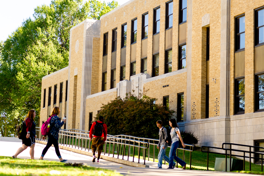 Students walk near the outside of the NYITCOM-Arkansas building on the Arkansas State University campus.