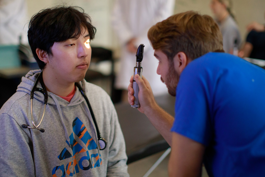 Providing preventative screenings to the Mississippi Delta community, an NYITCOM-Arkansas student assesses a patient's vision.