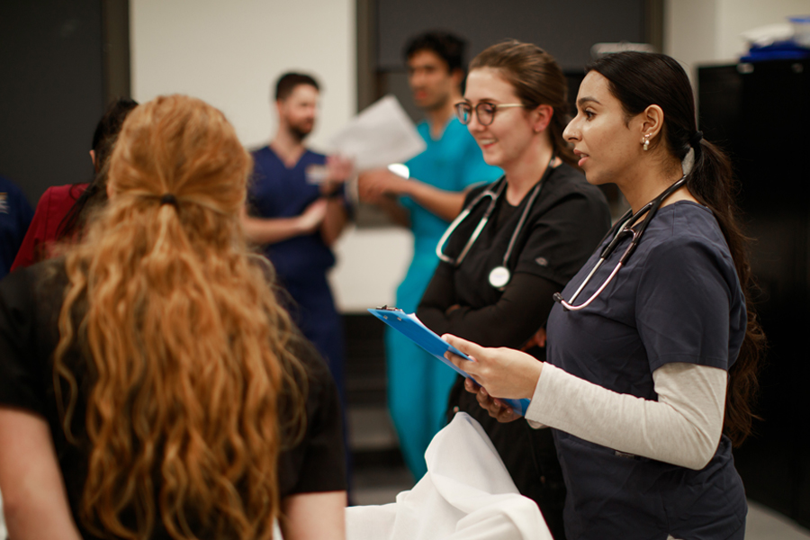 Medical students observe an exam.