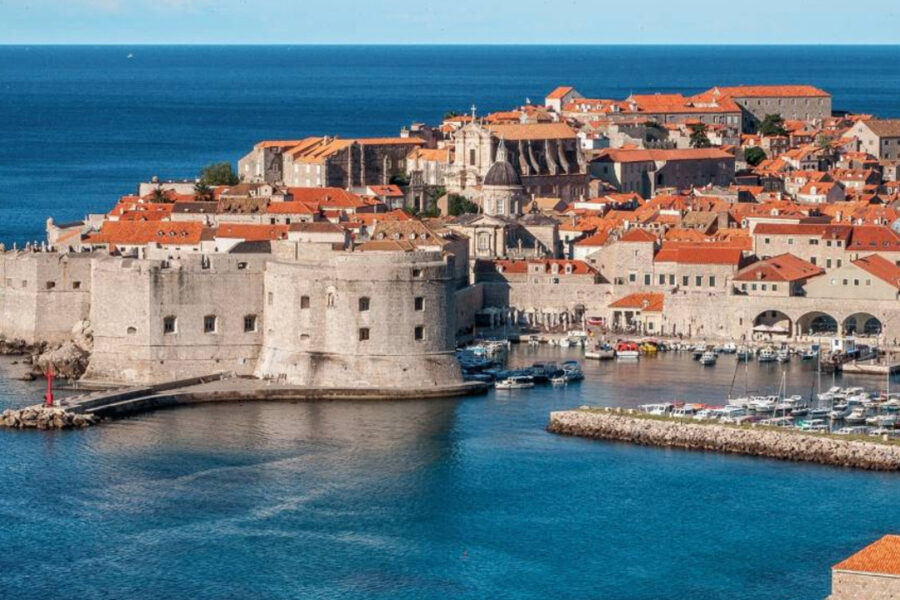 View of a castle on a bright blue coast.