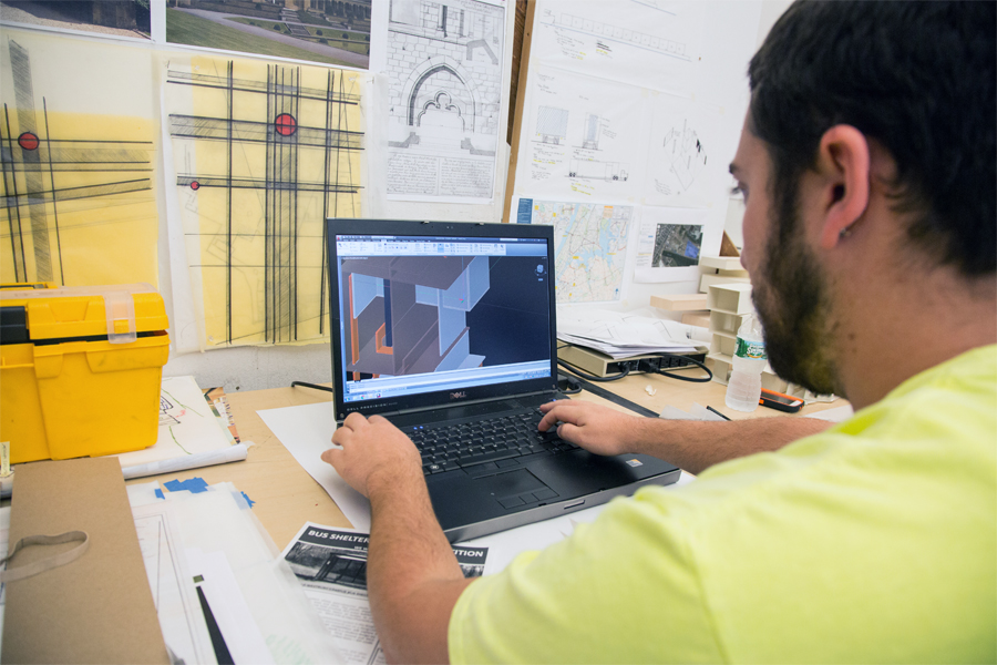 A student works on a rendering on a laptop