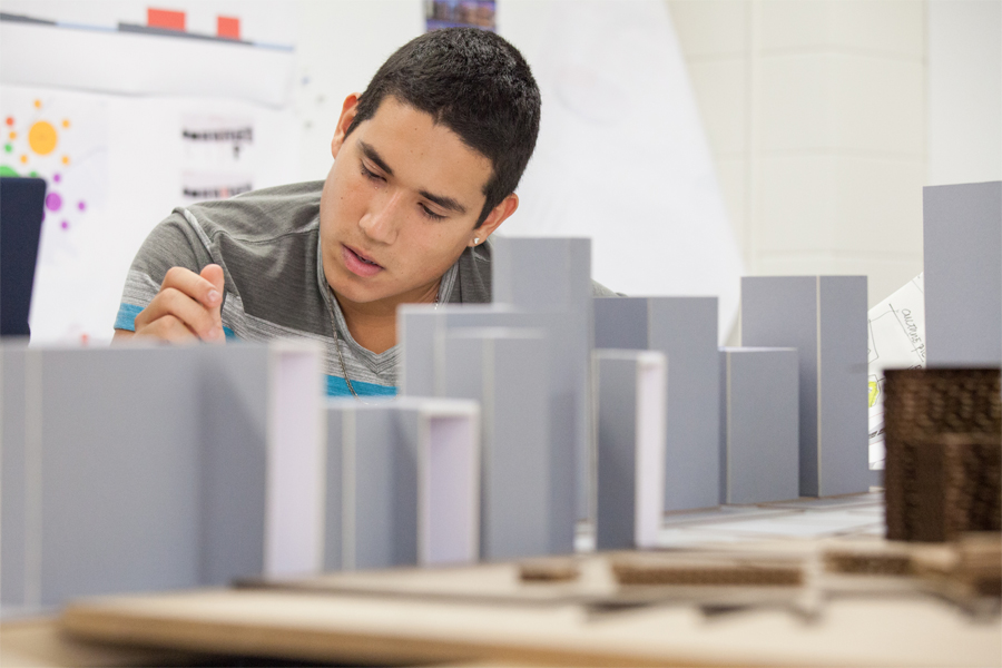 A student working on an urban city model project in a fabrication lab.