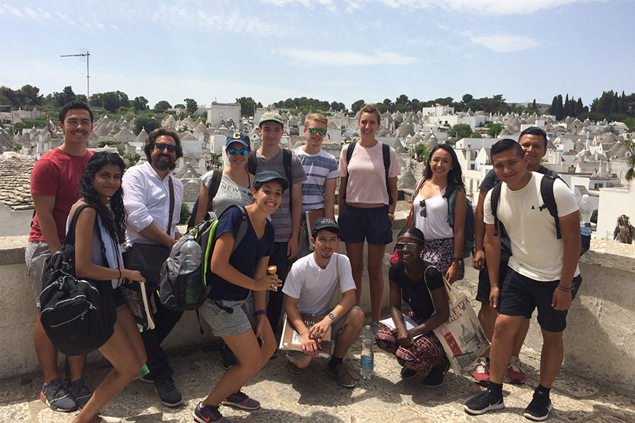 A group of New York Tech Architecture students stands outdoors to pose for a photo during a Summer Abroad trip.