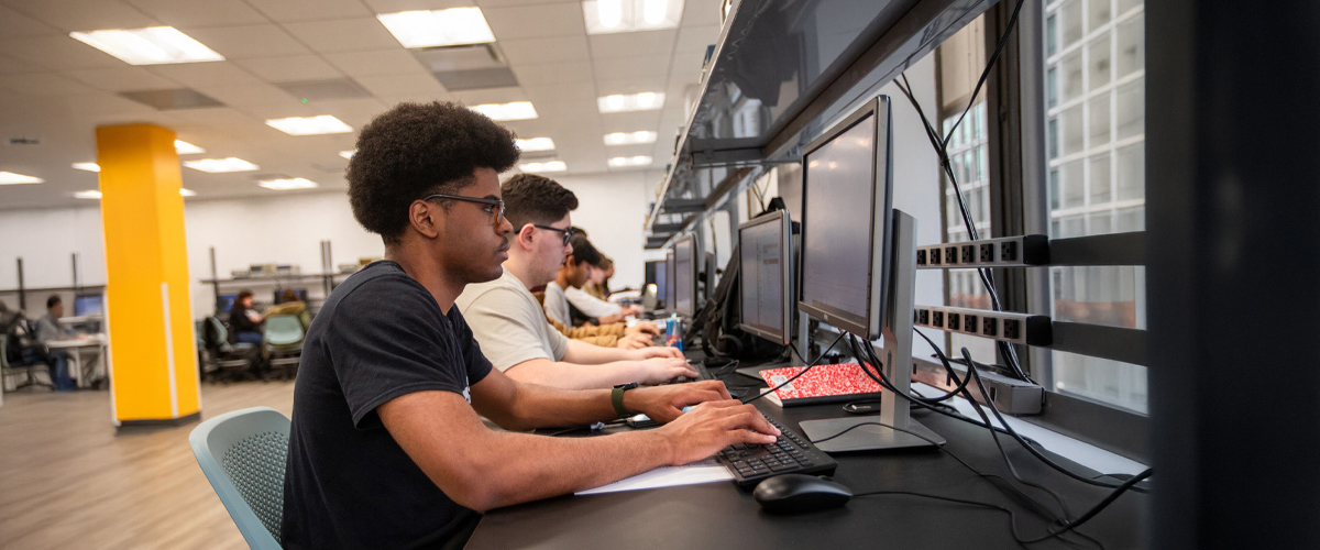 A student in a classroom using a computer