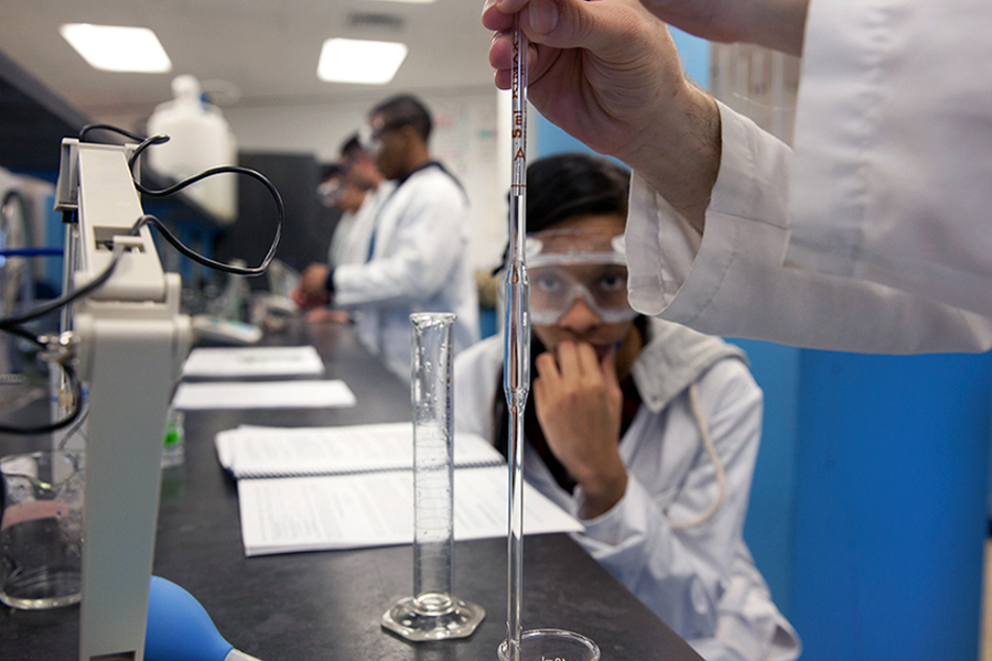 A student assesses an experiment in a science lab.