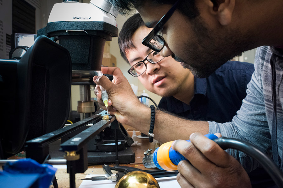 Two students work on a technology project.