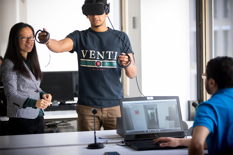 A student works with VR technology and is being monitored for research.