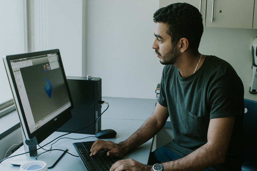 A student works on a computer modeling project in a lab. 