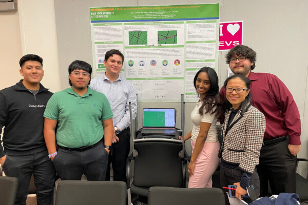 A group of six students in front of a project board.