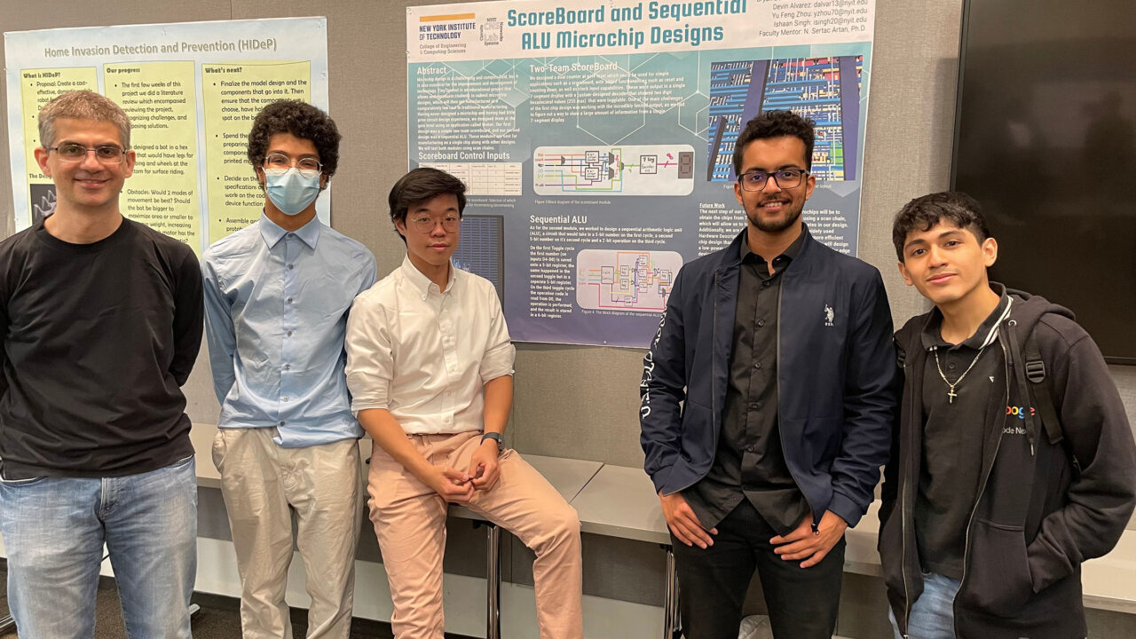 A group of five students in front of a project board.