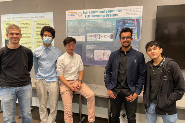 A group of five students in front of a project board.