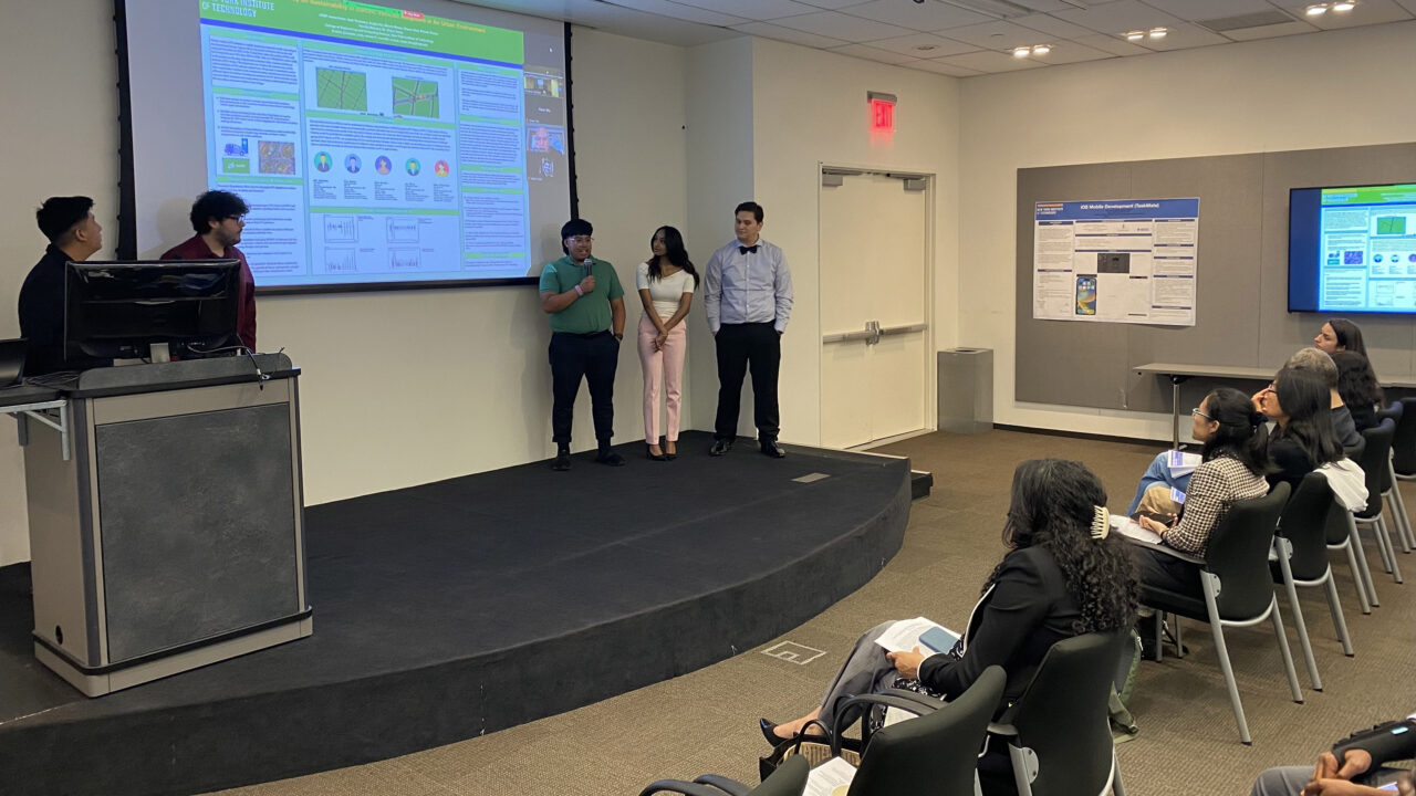 A group of students presenting their project in front of a classroom.