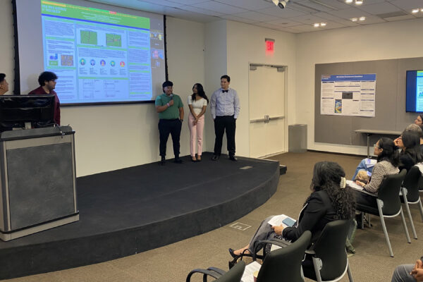 A group of students presenting their project in front of a classroom.