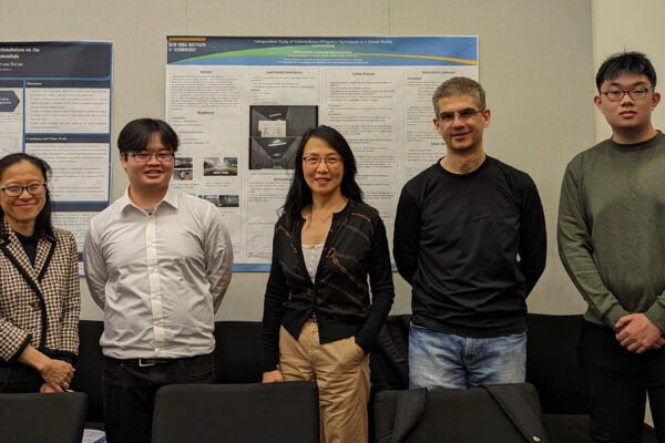 A group of five students standing front of their project boards.