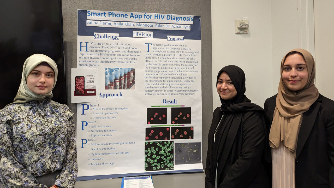 Three students standing in front of their project board.