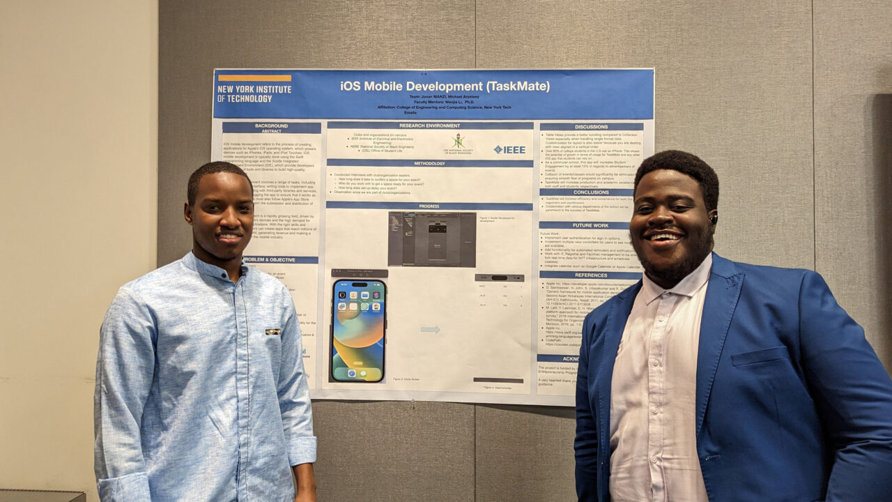 Two student standing in front of their project board.