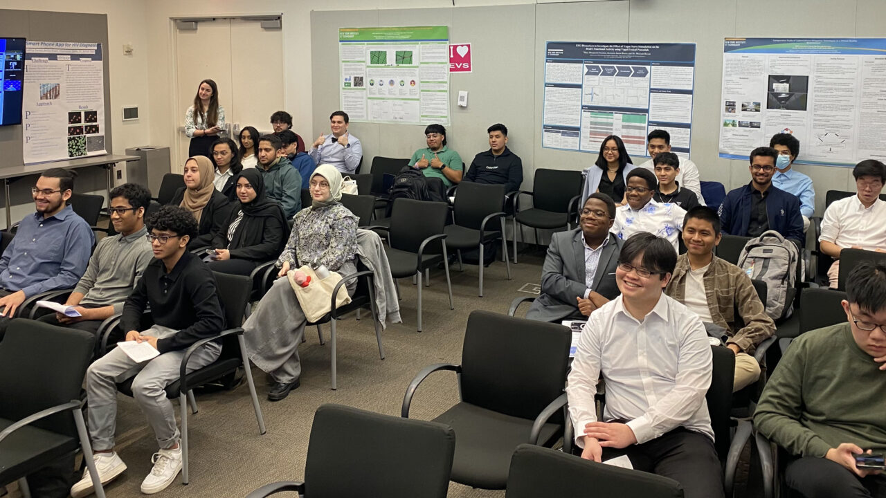 A classroom full of students with project boards around them.