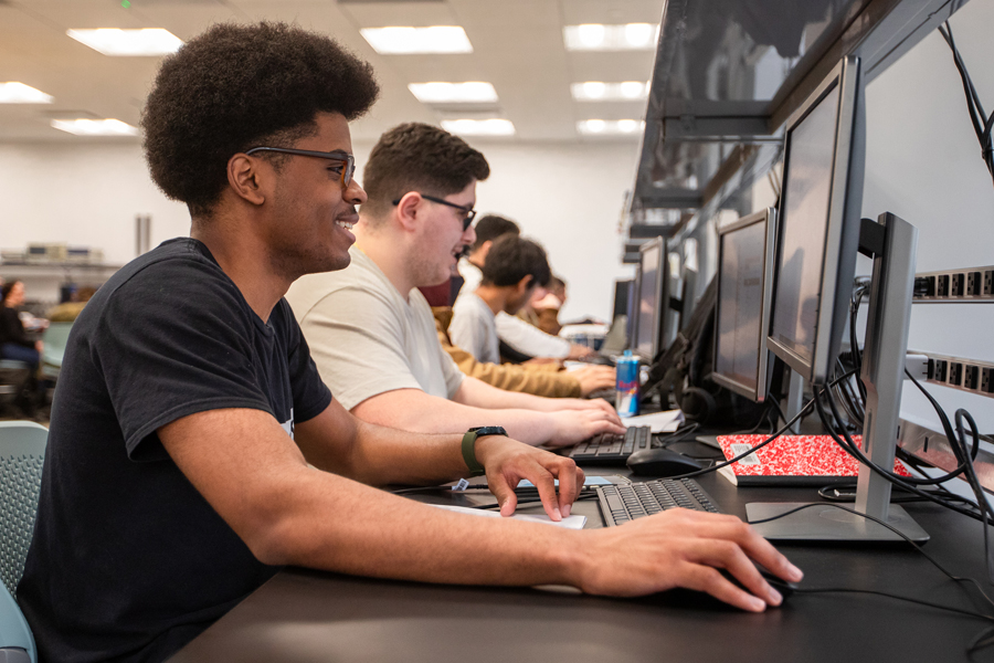 Student seated in a computer lab. 