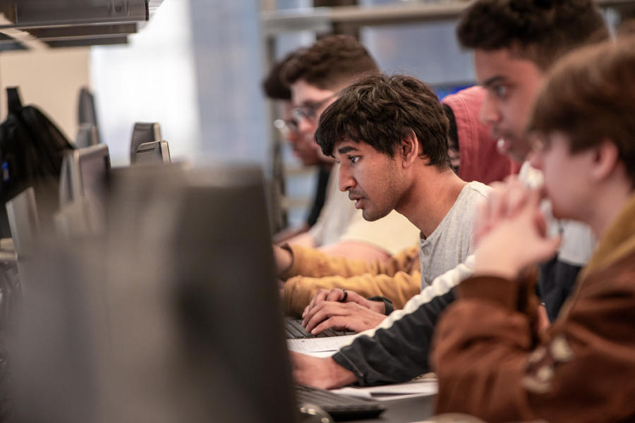 Student seated in a computer lab. 