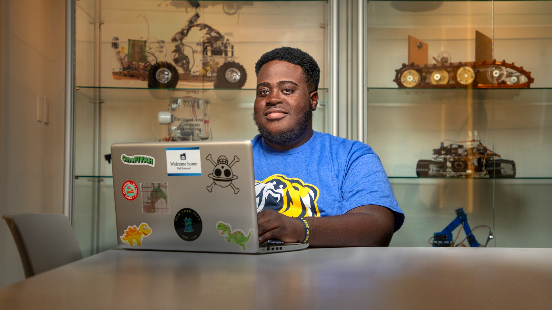 A student sitting at a table with a laptop. 