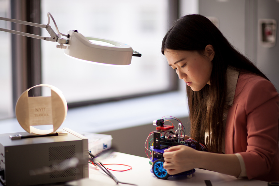 A student working her project in in a lab. 