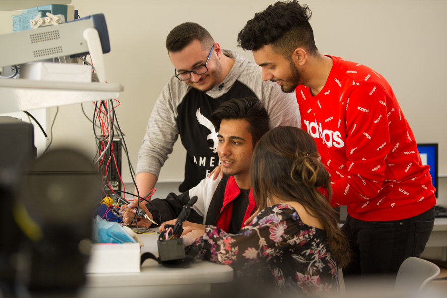 A group of 4 students work in the Materials Lab in the College of Engineering and Computing Sciences. 