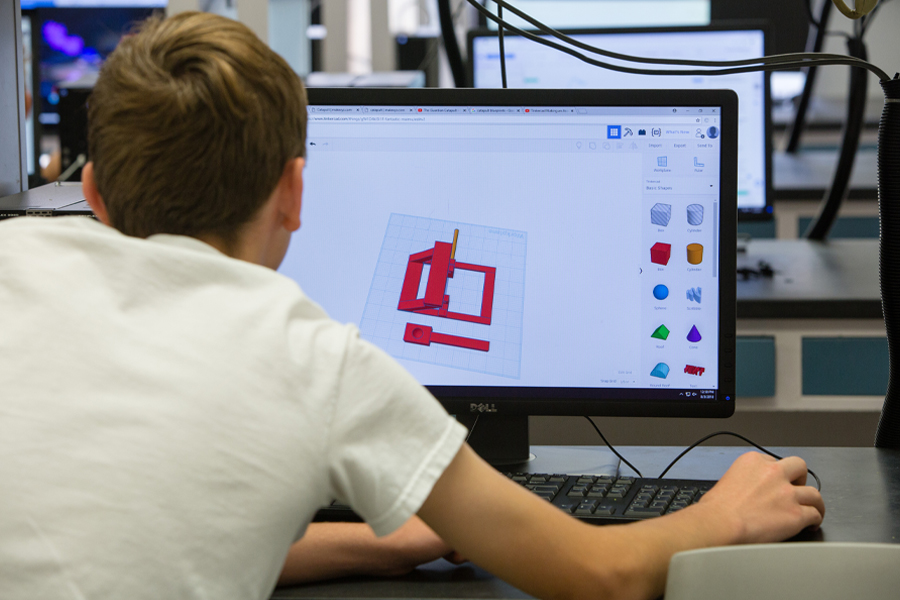 A student working on a CAD project in a lab.