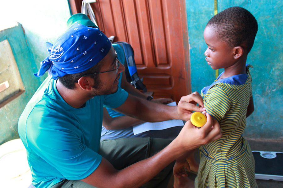 A person practice medicine abroad helping a child.