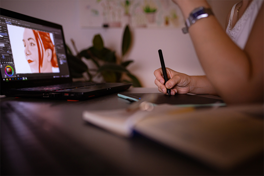 A student takes notes while viewing an animation.