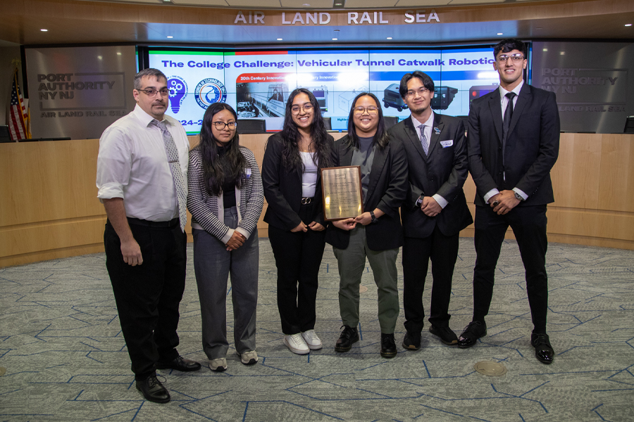 Group of students and professor holding award